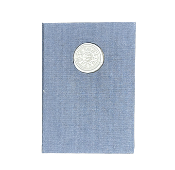 Navy notebook with a wax seal on a white background
